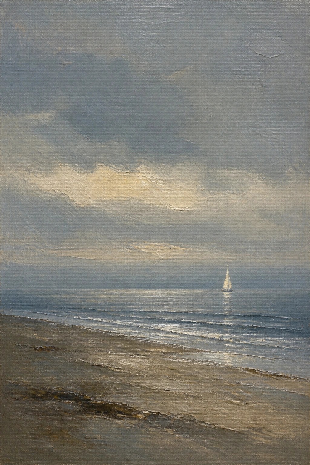 Waves rolling onto sandy beach under cloudy sky with distant sailboat