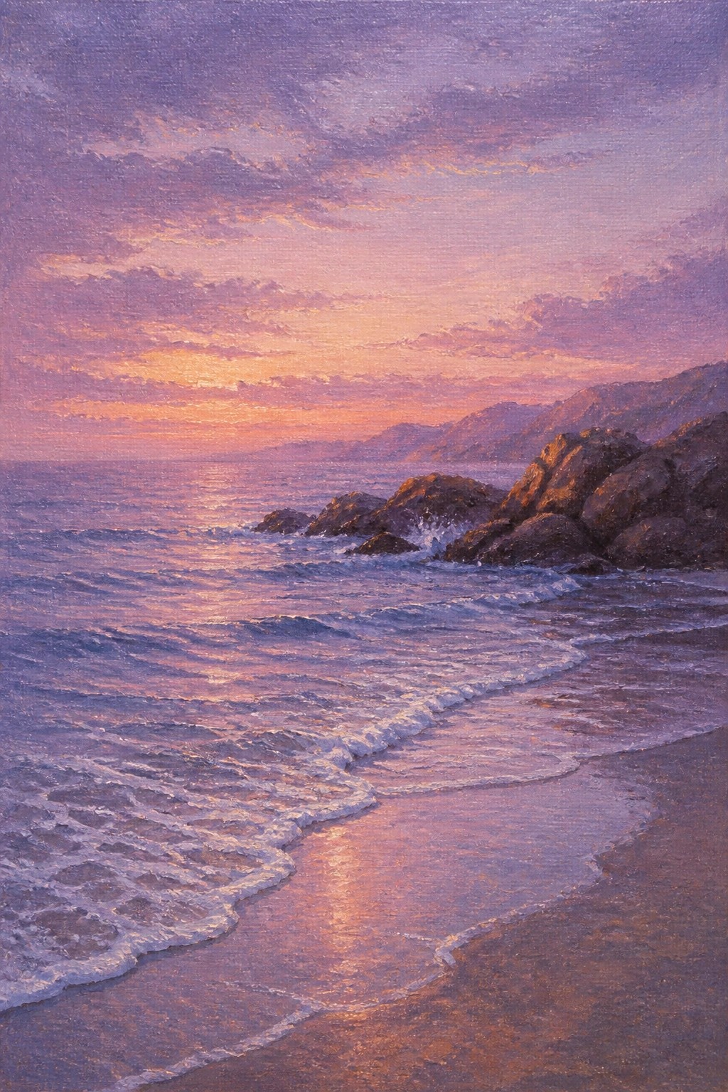 Waves rolling onto sandy beach under purple-orange sunset sky with rocky cliffs