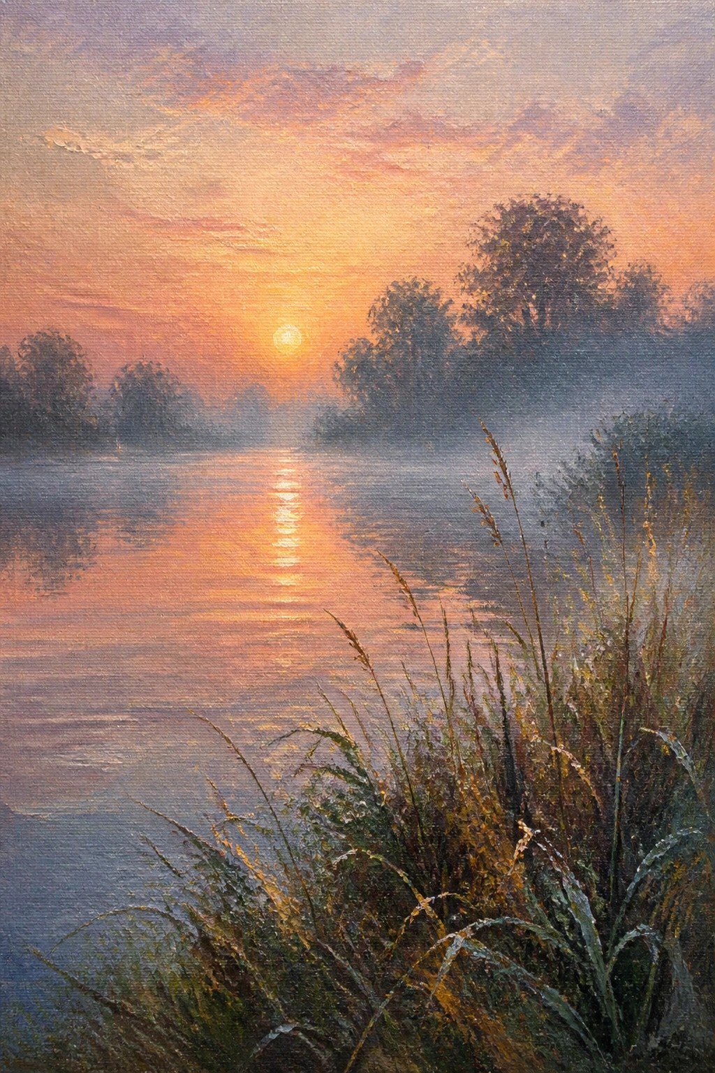 Golden sunrise reflecting on misty river with foreground grasses and trees