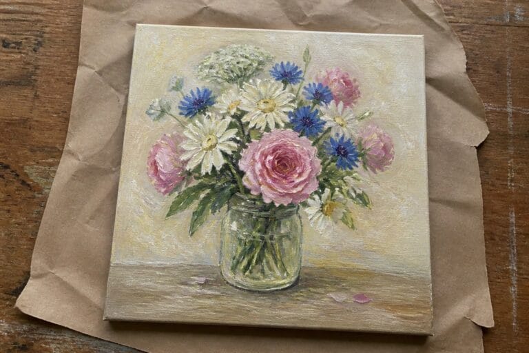 Oil painting of pink roses, blue cornflowers, and daisies in a glass mason jar