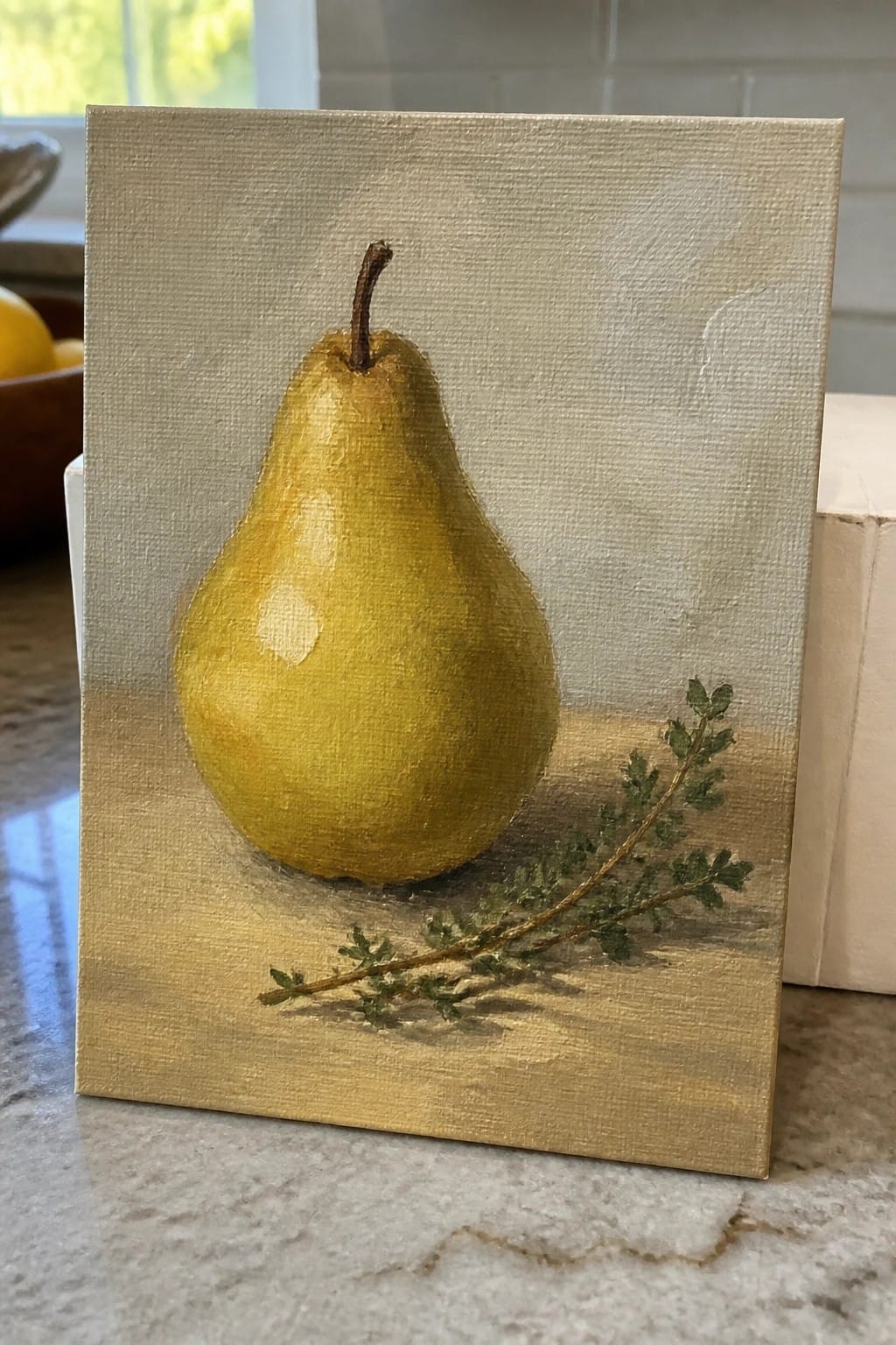 Still life painting of yellow pear with stem beside green herb sprig on canvas