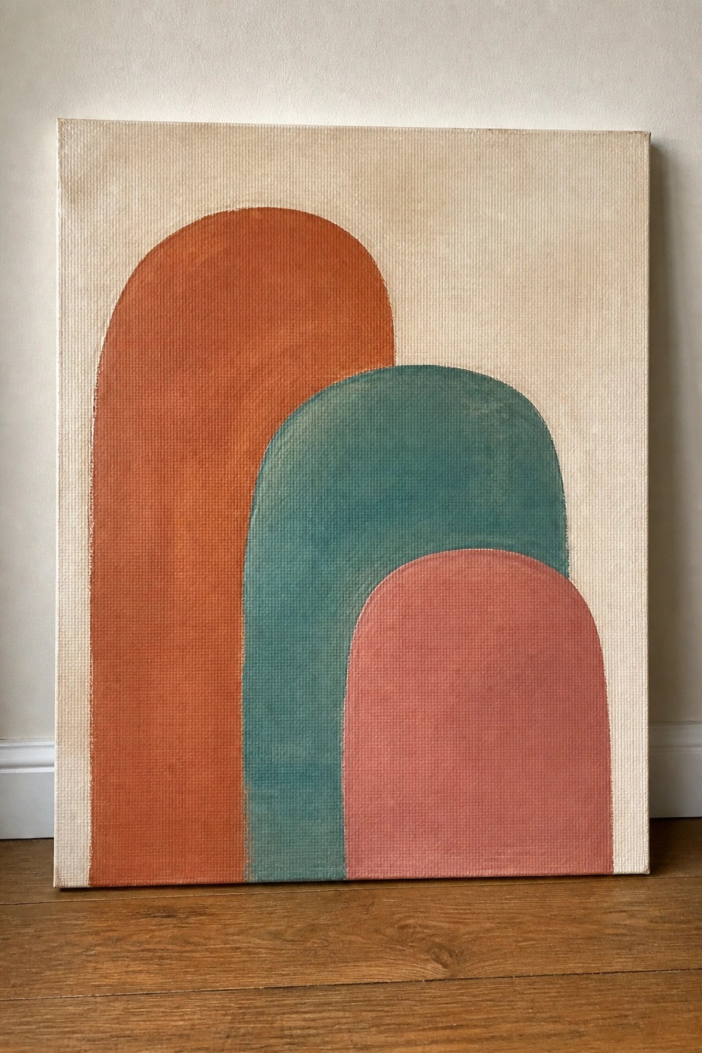 Abstract painting with overlapping arches in orange, teal, and pink on beige canvas.