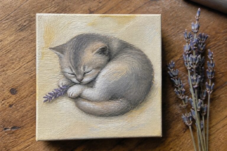 Small canvas painting of sleeping kitten with lavender beside dried flowers on wood
