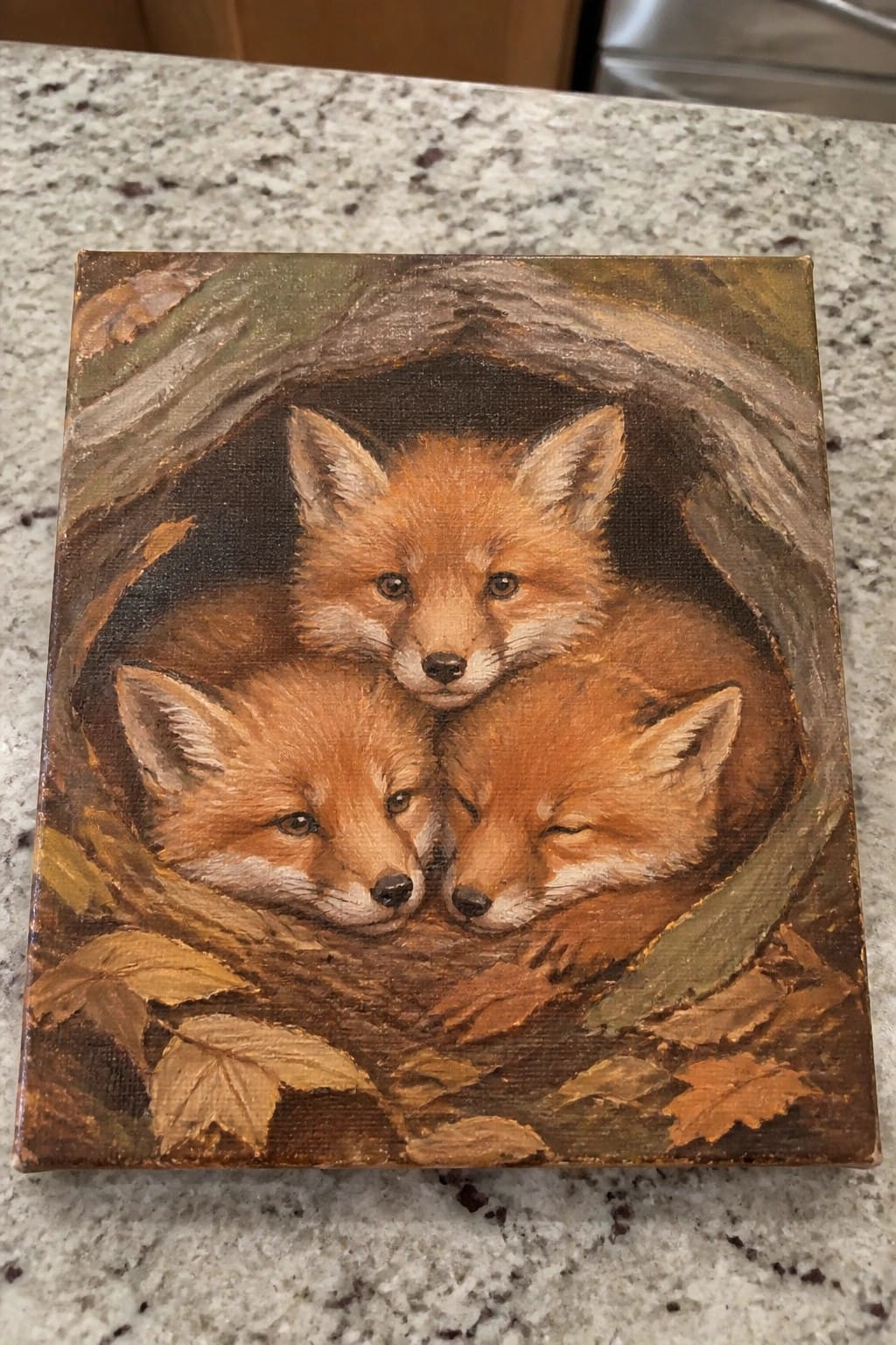Three fox kits nestled in a hollow tree stump amid autumn leaves, realistic oil painting.
