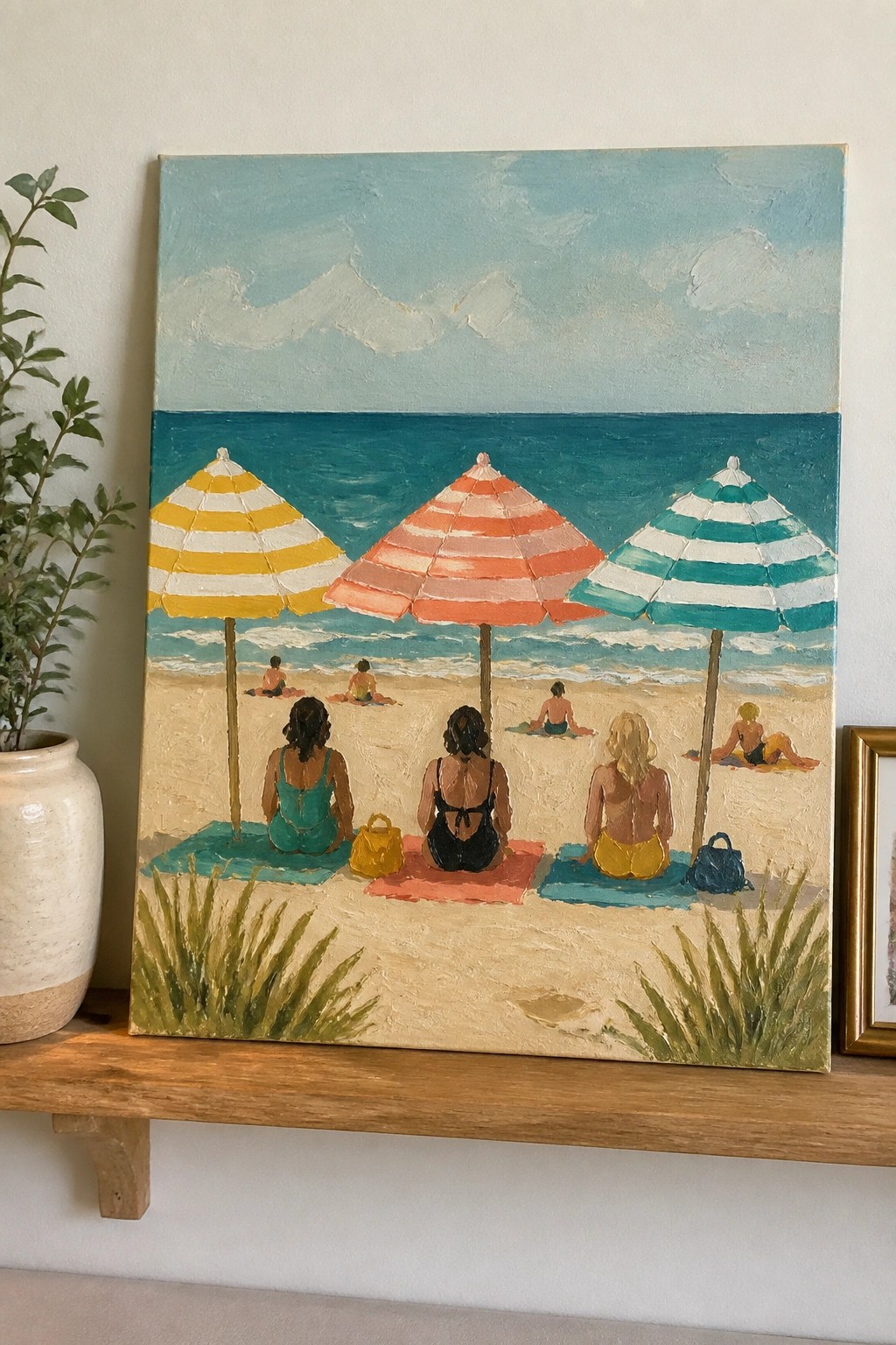 Painting of three women on towels under yellow, orange and teal striped beach umbrellas.