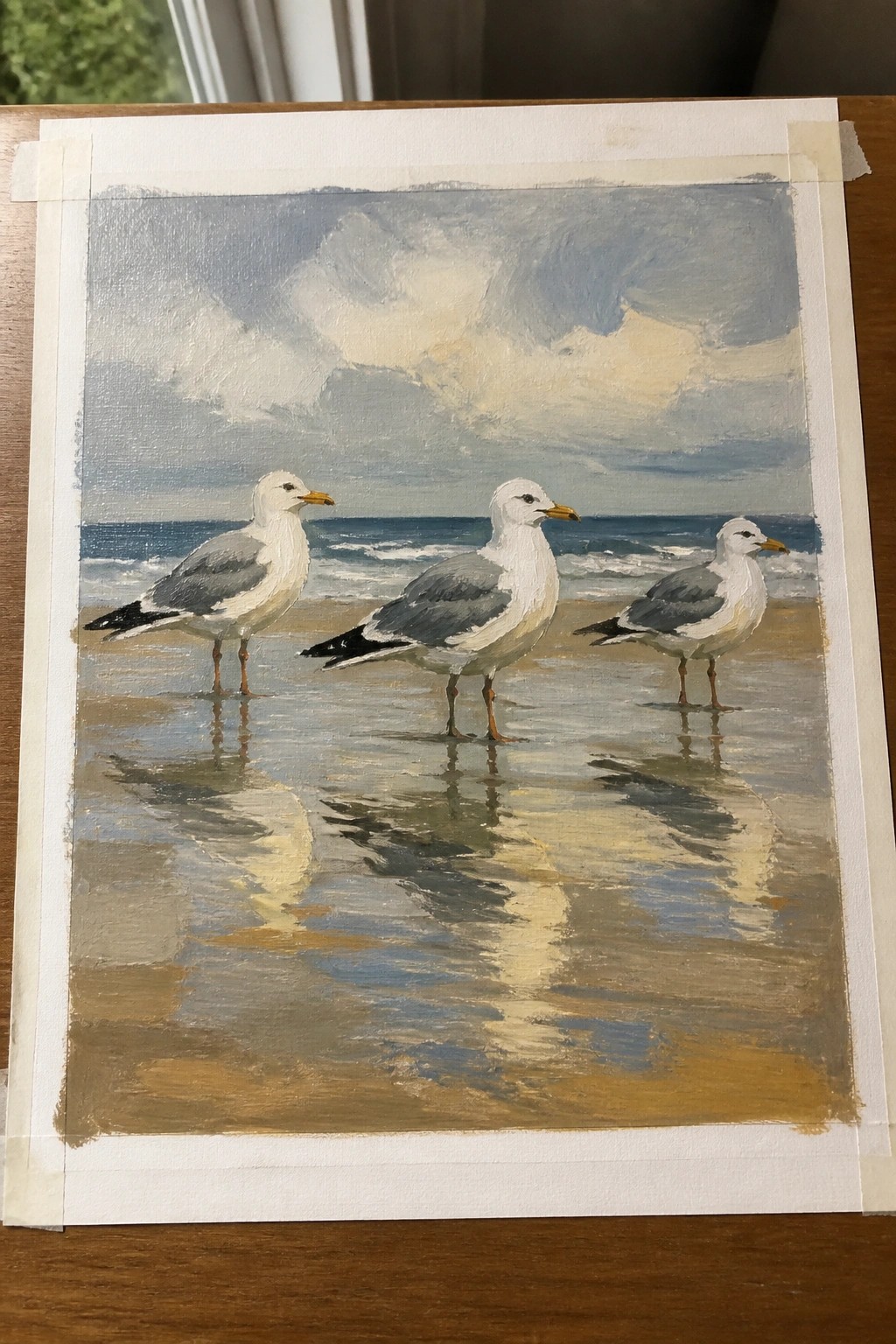 Oil painting of three seagulls on wet sand with ocean and sky reflections under clouds