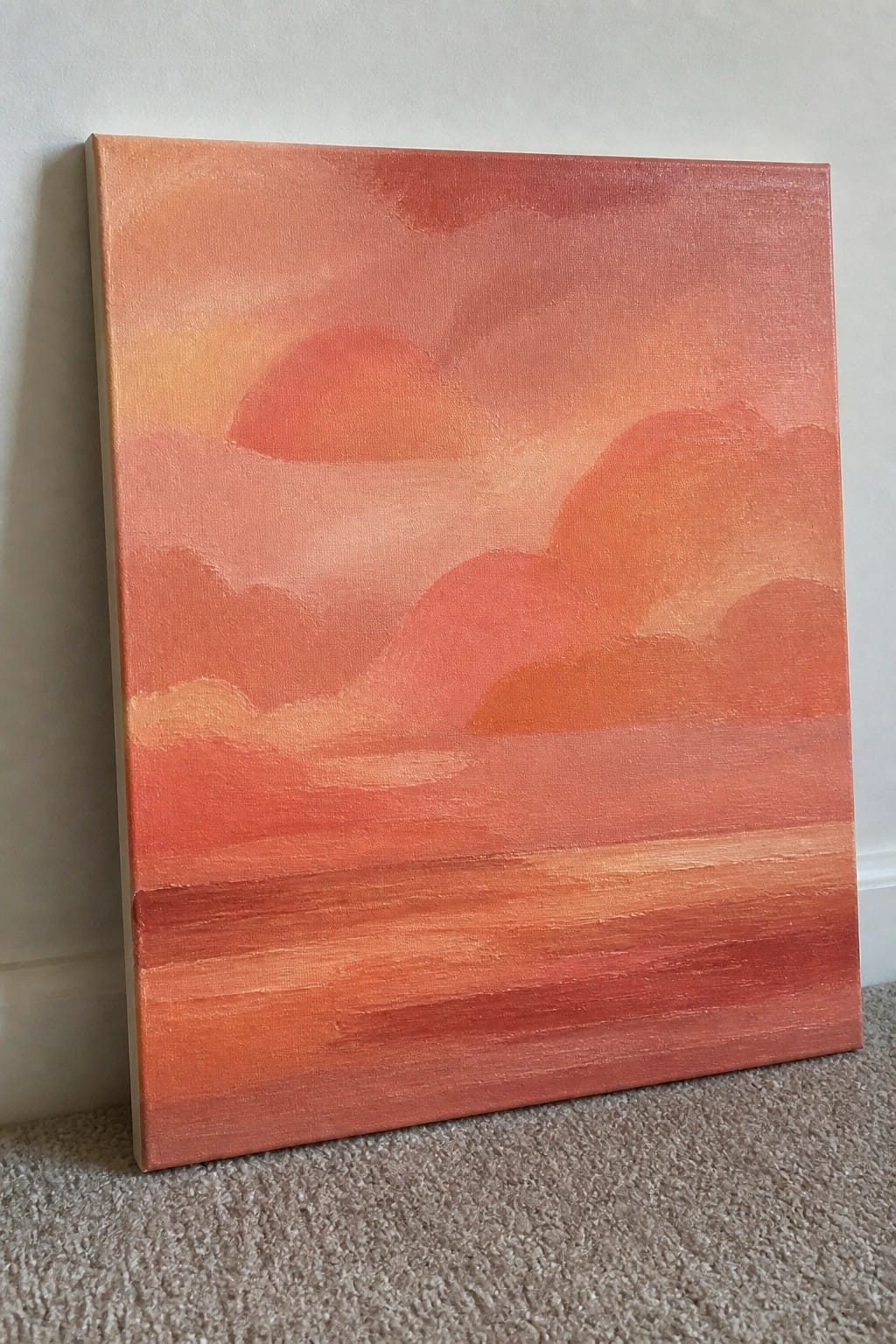Abstract canvas painting of vibrant orange-red sunset with layered clouds and horizon.