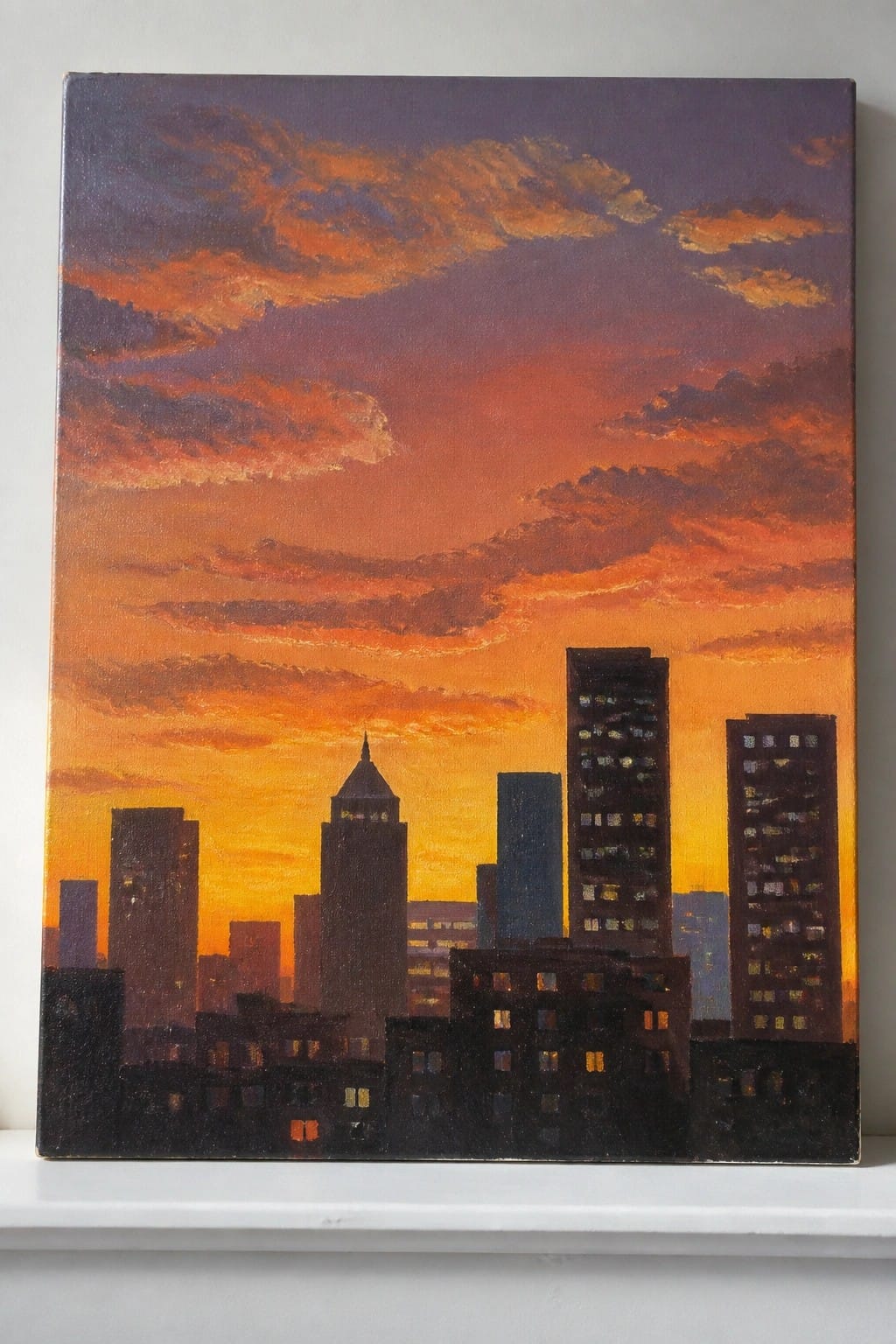 An oil painting of a city skyline silhouetted against a vibrant orange and purple sunset sky with scattered clouds.