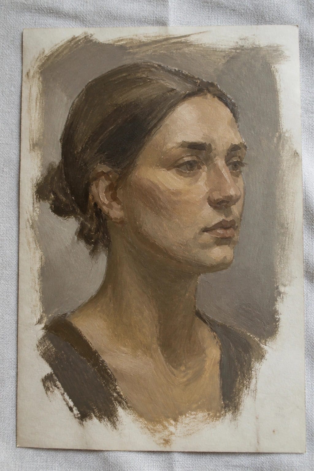 Earth-toned oil portrait of woman with dark hair in rightward profile view