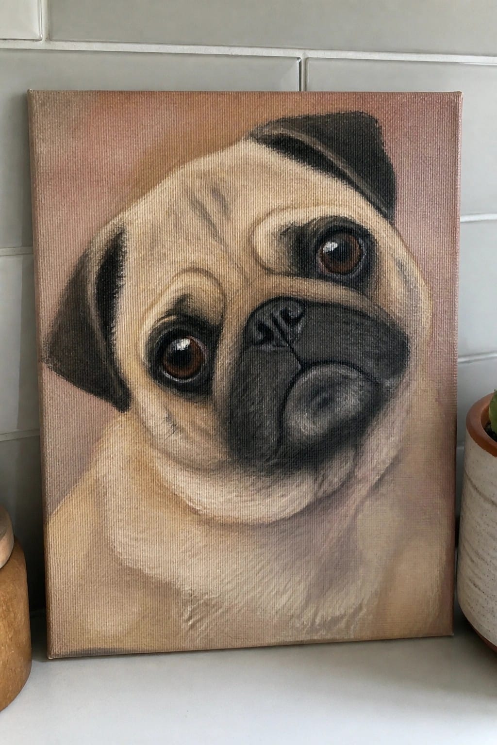 A realistic oil painting of a pug's face centered on a canvas with soft blended fur and a muted background.