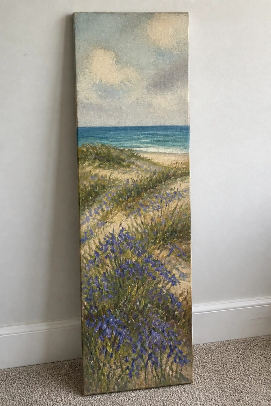 Tall vertical painting of purple flowers on sandy dunes overlooking the ocean.