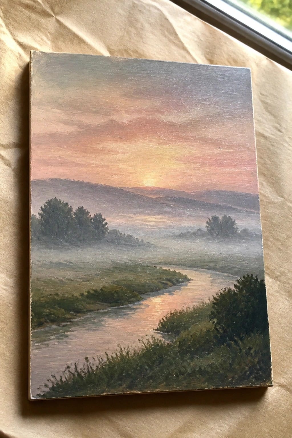 Oil painting of misty river winding through hills at pink-orange sunset with trees