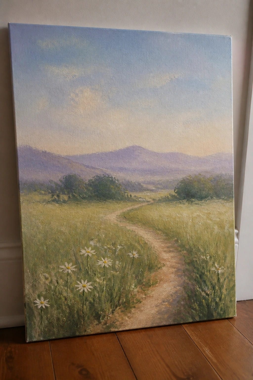 Oil painting of winding dirt path through daisies toward purple mountains