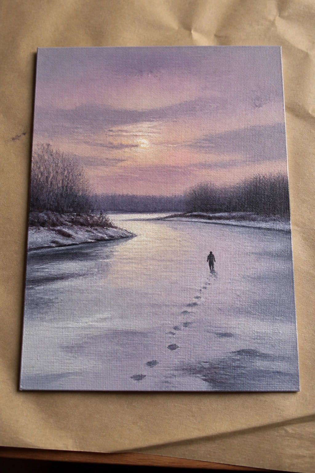 Realistic painting of lone figure walking on frozen river at purple-pink sunset with snowy banks