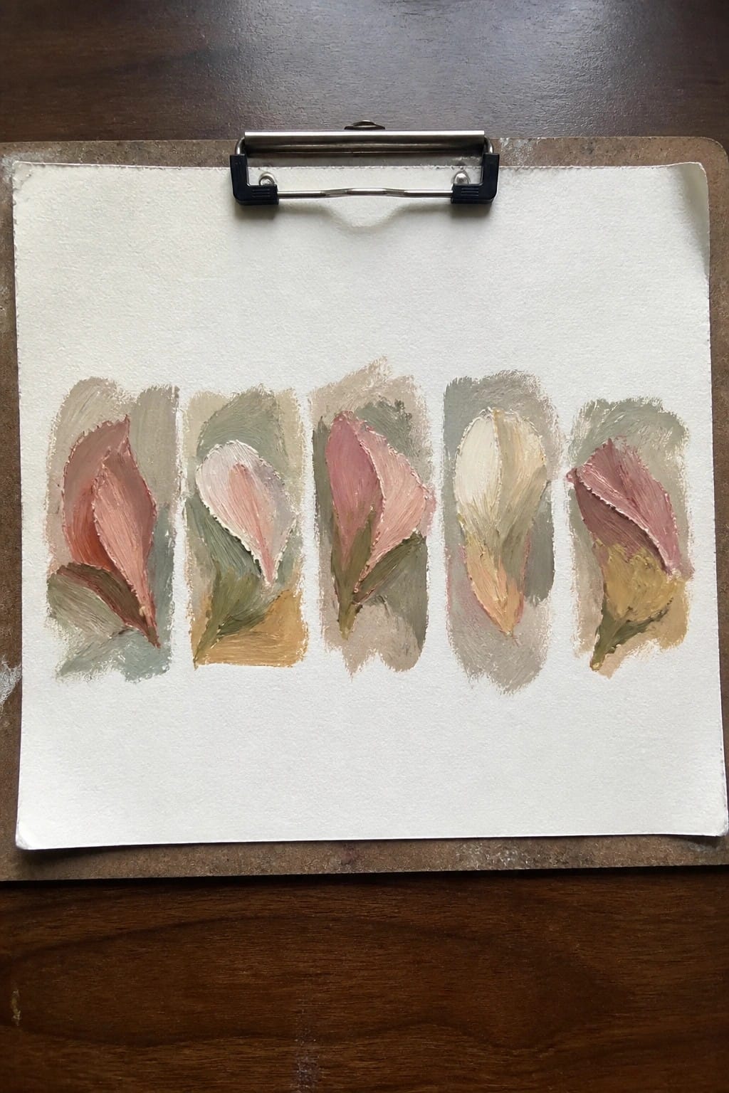 Five abstract pink and green floral paintings on paper clipped to a board.
