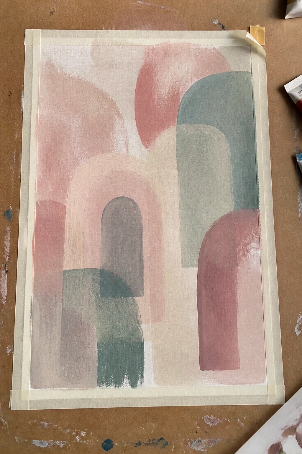 Abstract artwork with overlapping rounded arches in soft pink, red, and green tones