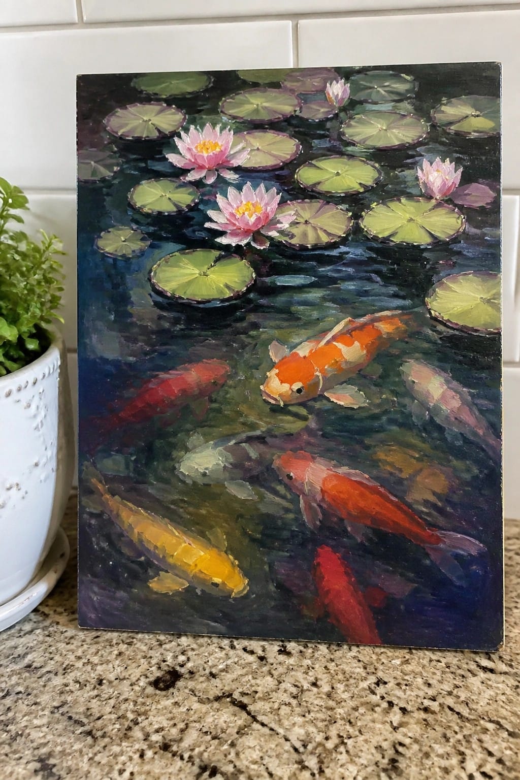 Colorful koi fish swim among green lily pads and pink blooms in a painting