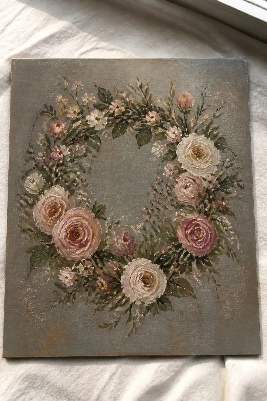 Floral wreath with pink and white roses on textured gray canvas