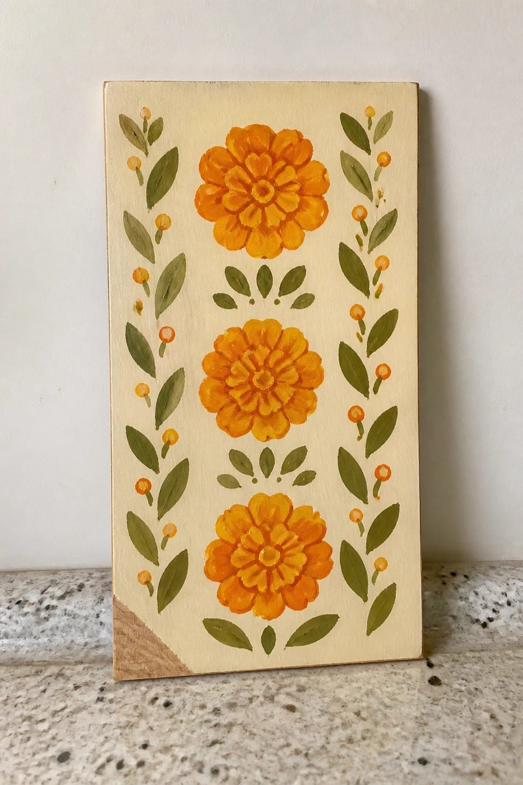 Wooden plaque with three orange flowers, green leaves, and buds on cream background