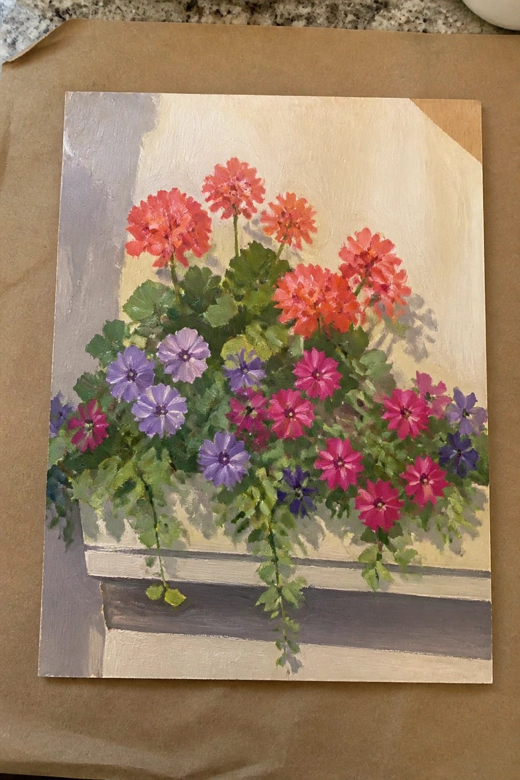 Vibrant painting of red, pink, and purple flowers in a white window box.