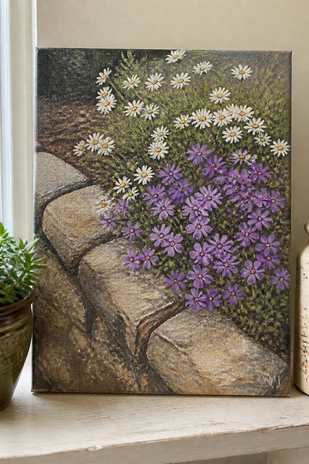 Canvas painting of white daisies and purple flowers among stone steps