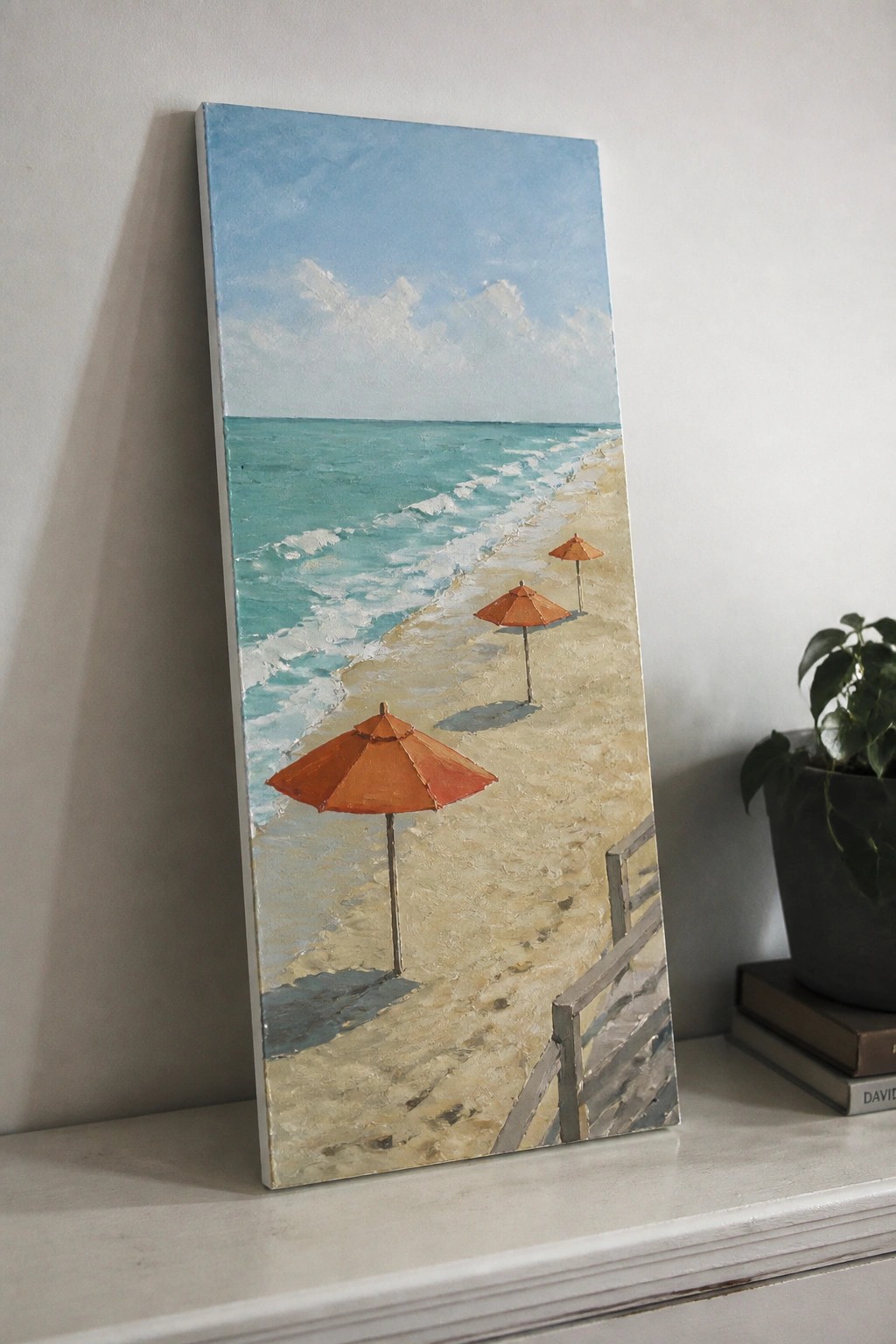 Painting of sandy beach with orange umbrellas, turquoise waves, blue sky, and wooden railing.