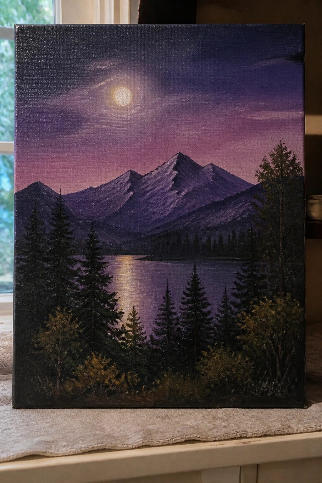 Mountain landscape painting with moonlit lake and pine trees under purple sky.