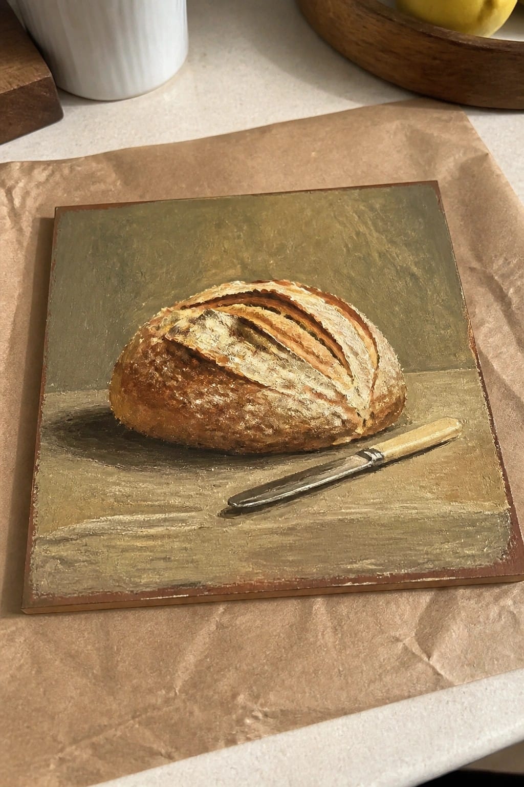 Realistic still life painting of crusty bread loaf and knife on green background
