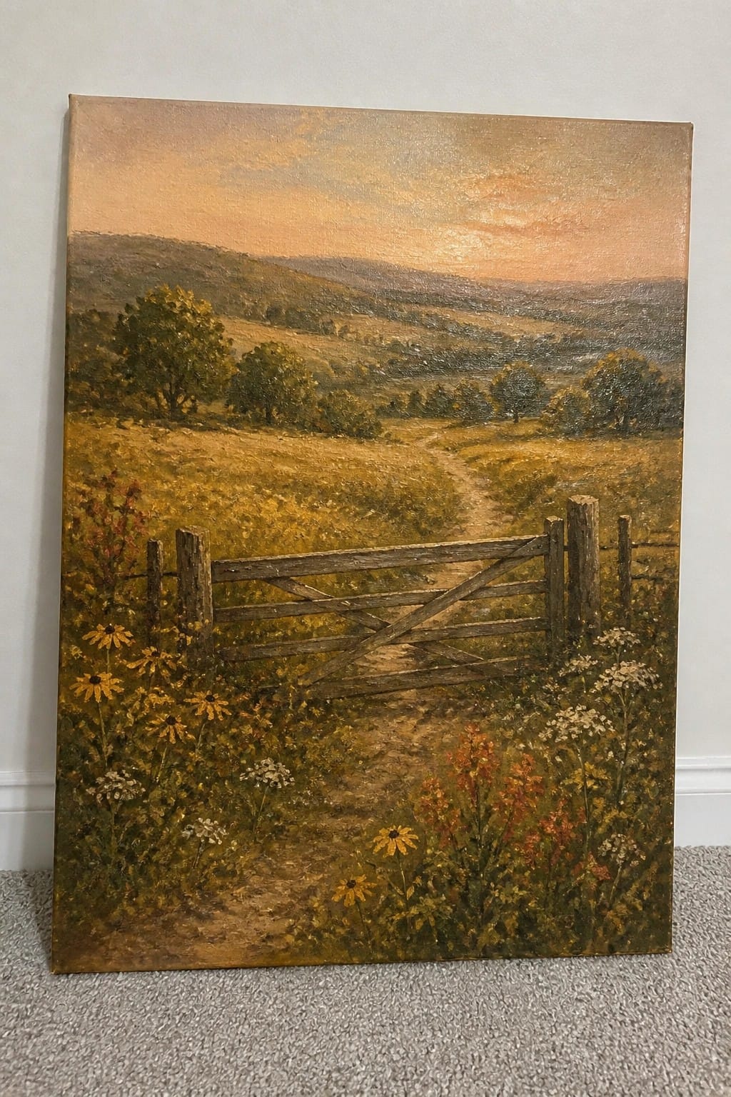 Oil painting of wooden gate amid wildflowers, dirt path, golden fields, and sunset hills.
