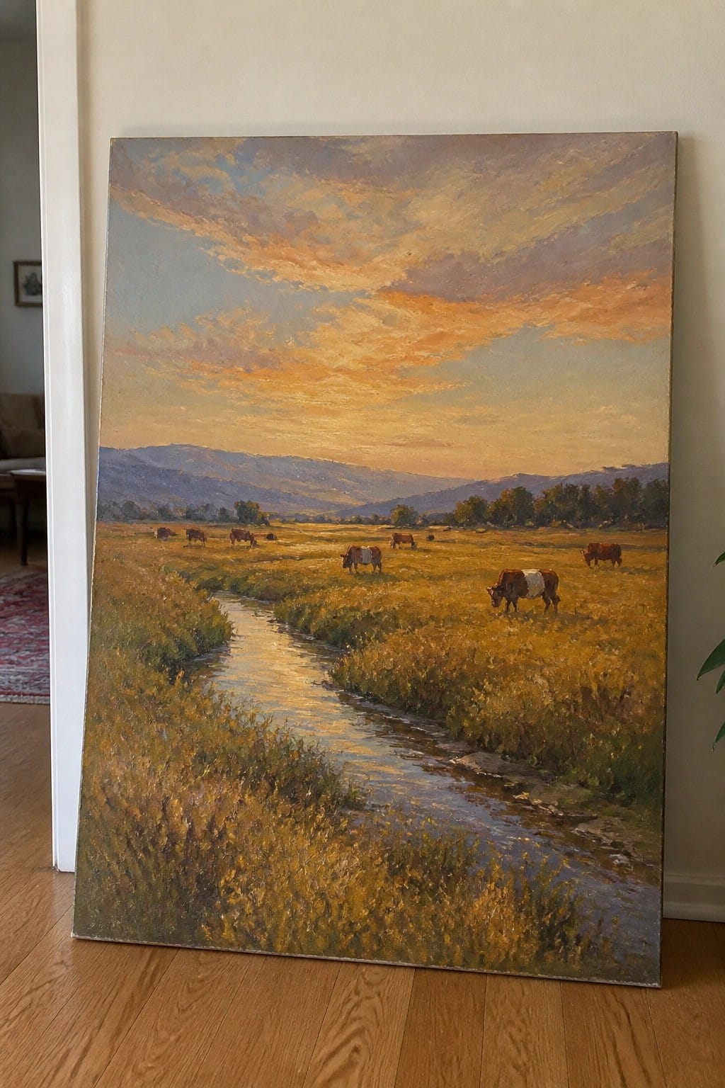 Pastoral landscape painting of cows grazing in a golden field by a stream at sunset