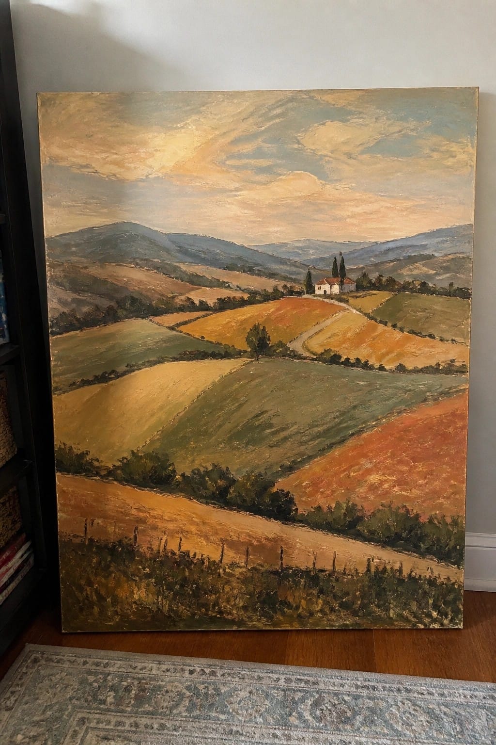 Oil painting of rolling colorful hills, fields, villa, and distant mountains under clouds.