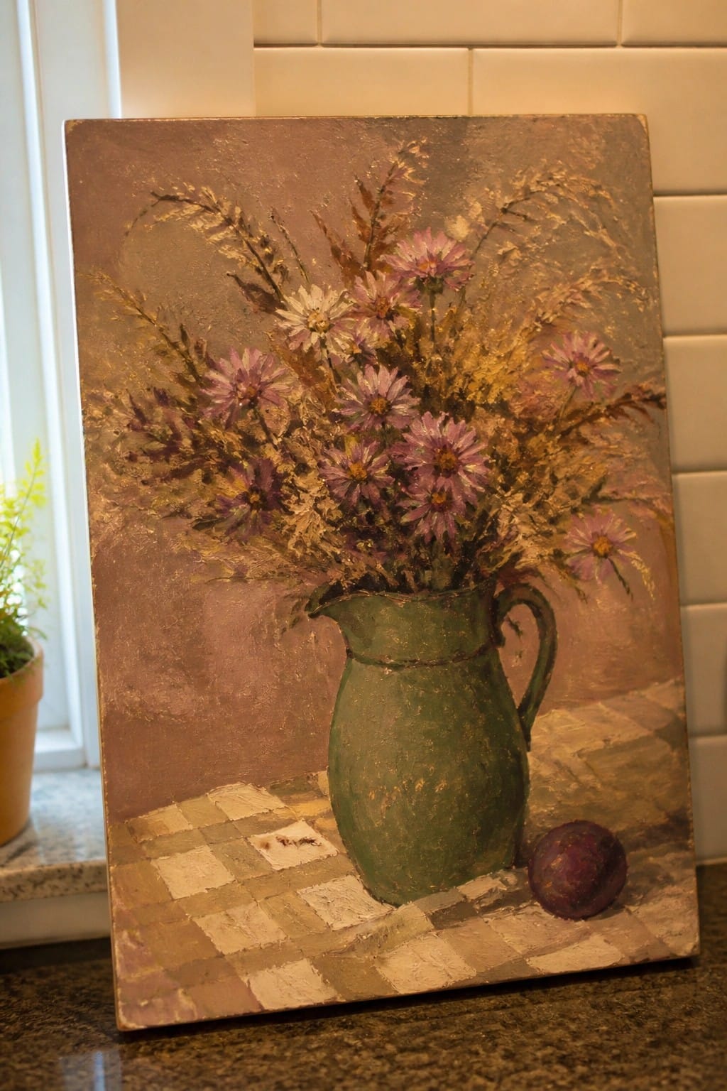 Impasto painting of purple flowers in green pitcher beside beet on checkered cloth