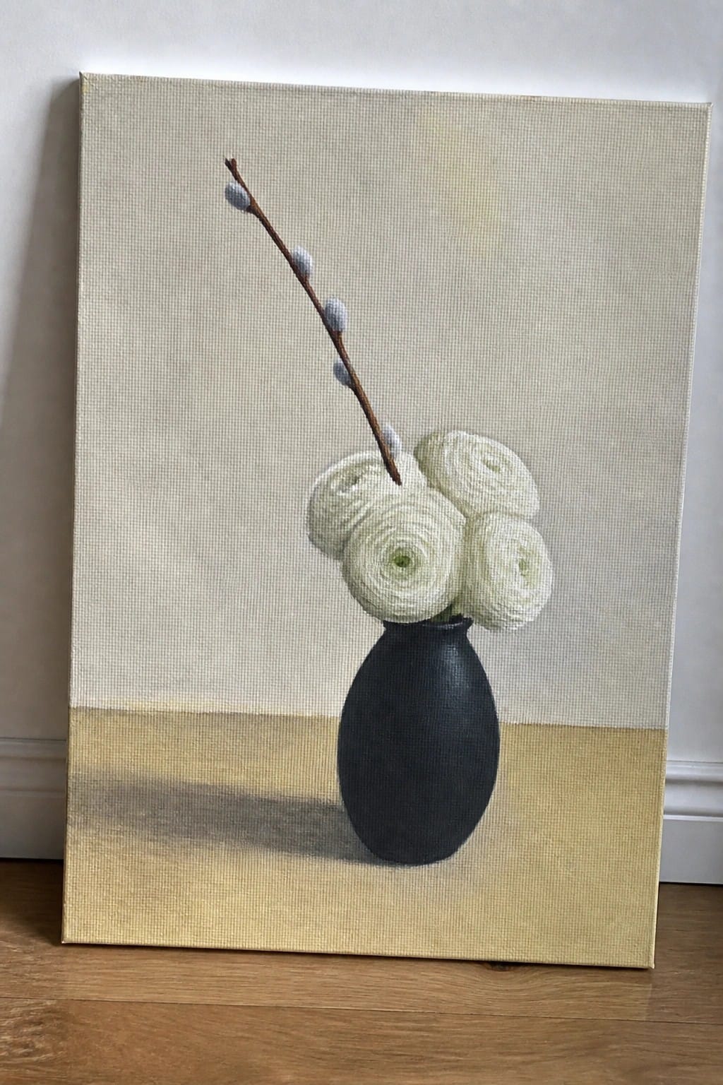 Painting of white ranunculus in black vase with budding branch on yellow surface
