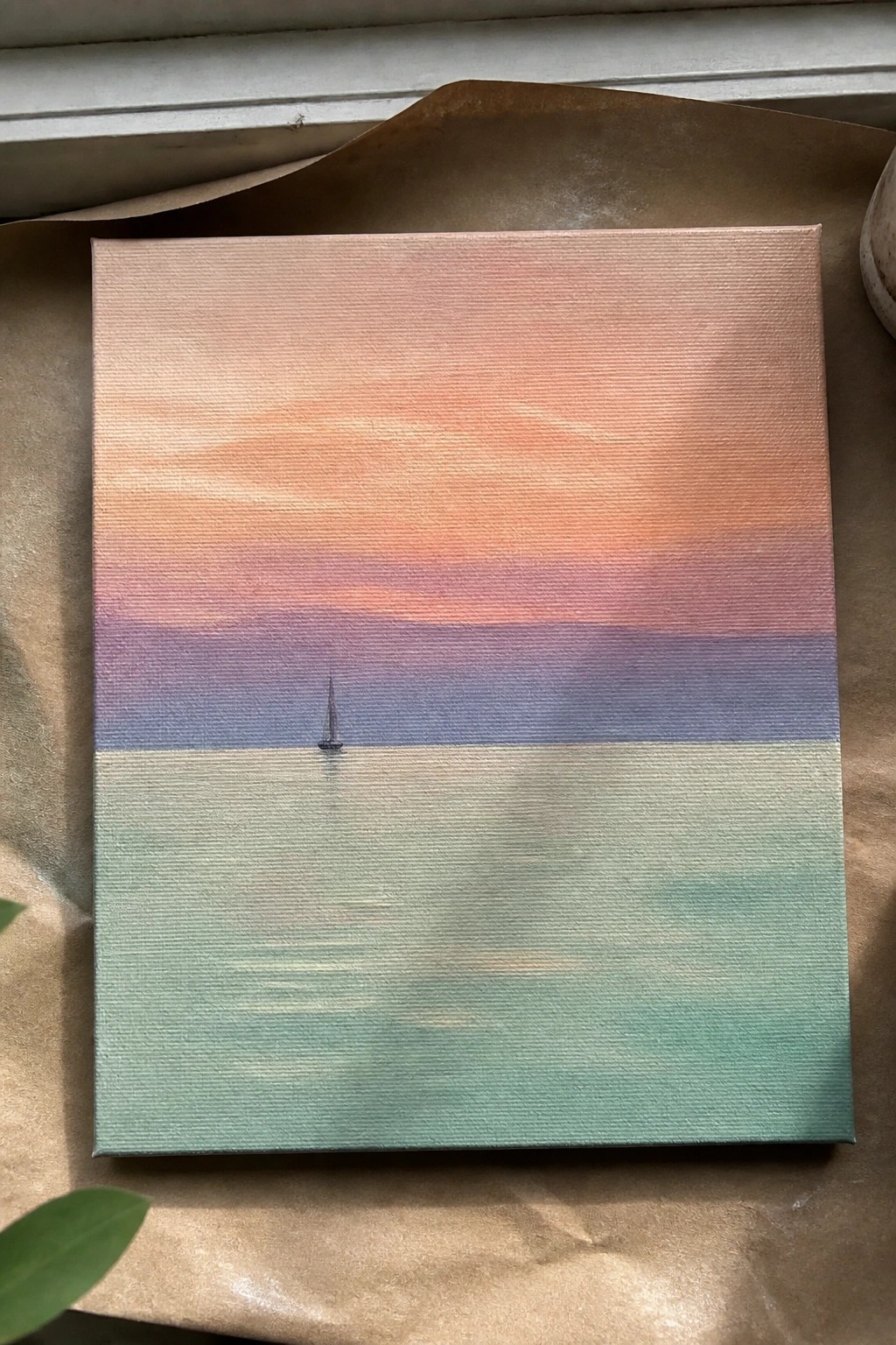 Square canvas painting of sailboat on calm sea under orange-purple sunset gradient sky.
