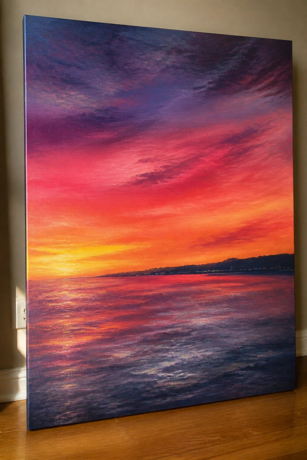 Vibrant canvas painting of red-purple ocean sunset with golden reflections leaning indoors