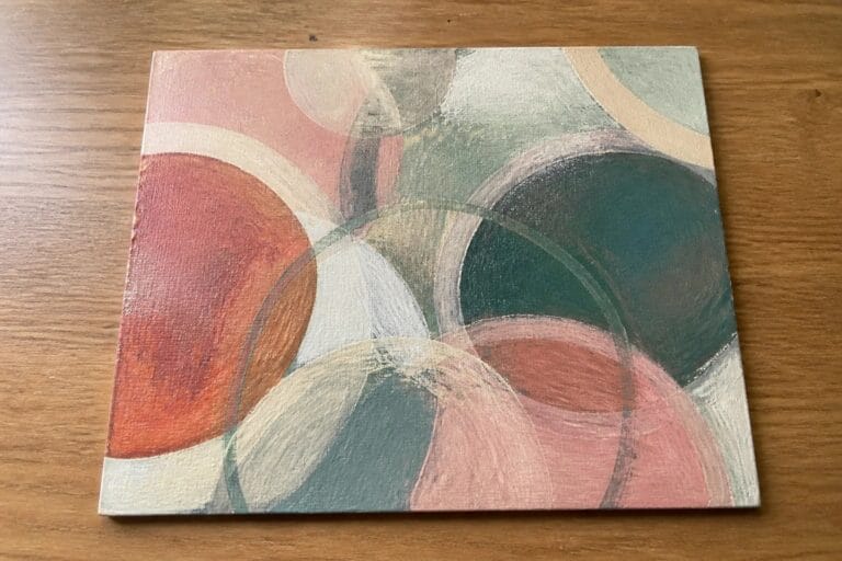 Abstract painting of overlapping circles in terracotta, teal, pink, and beige tones.