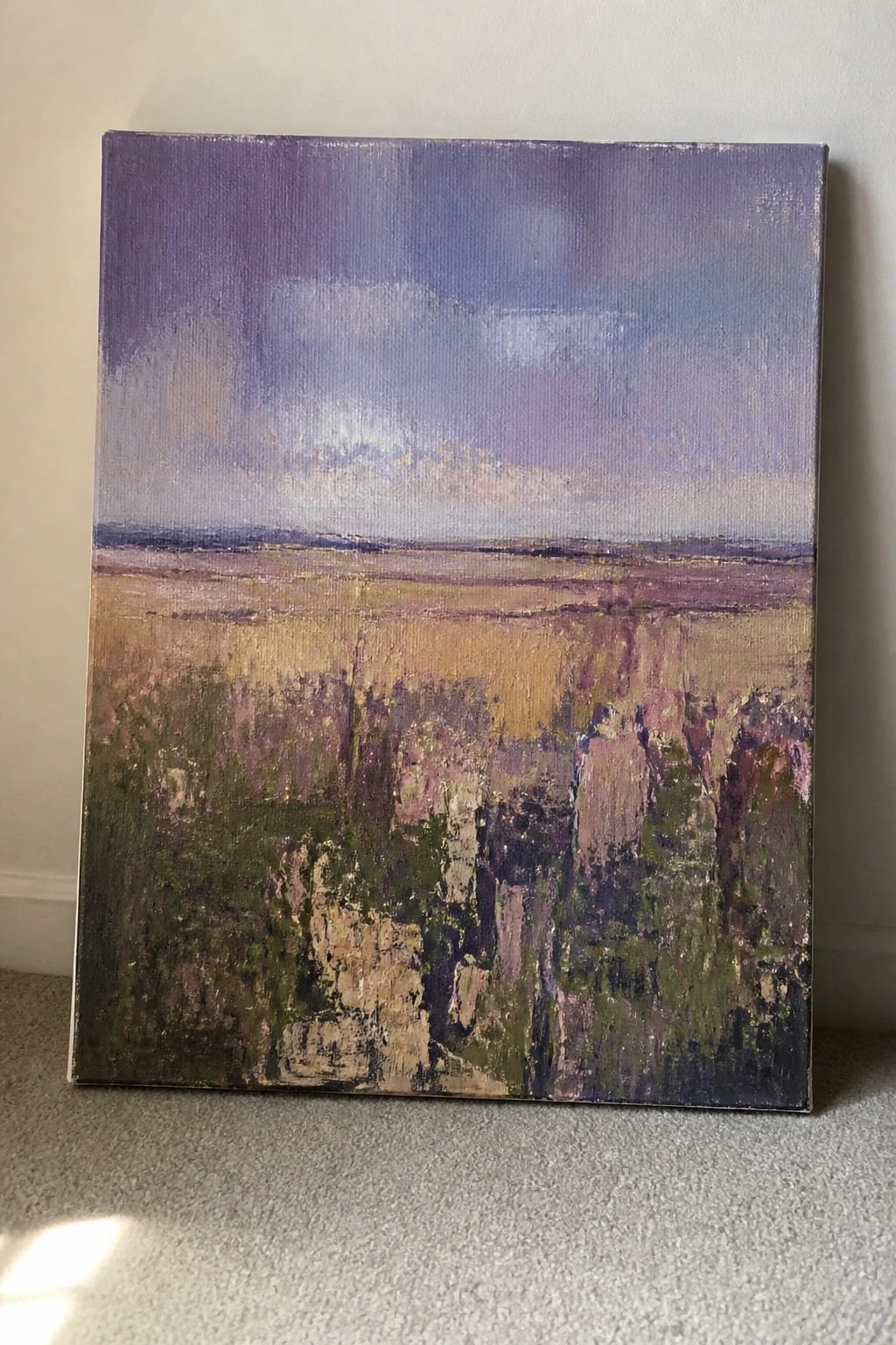 Impressionistic landscape painting with purple sky over textured golden and green fields on carpet
