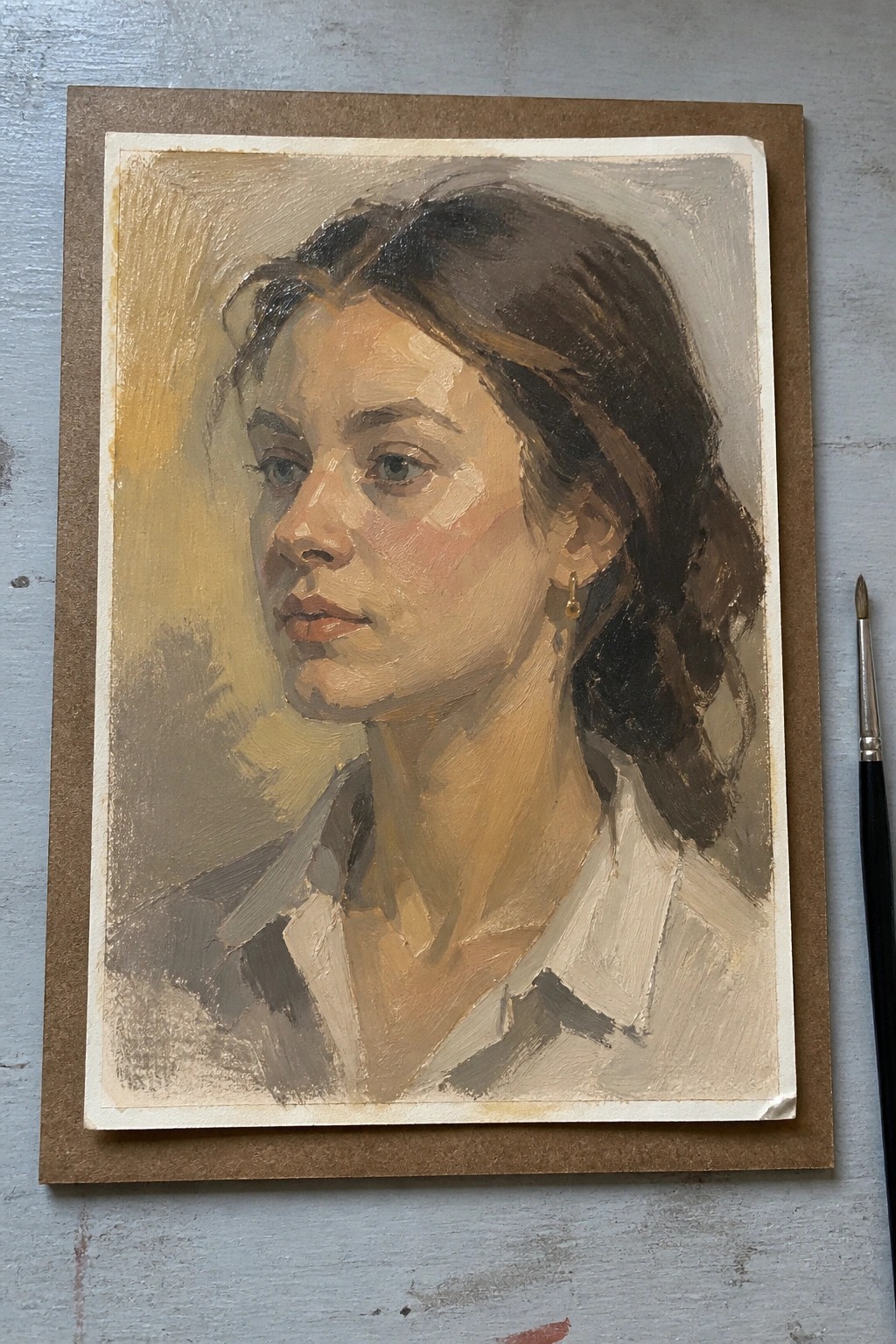 A small oil painting of a woman's face and shoulders in three-quarter view, with dark hair, a white shirt, and a muted background.