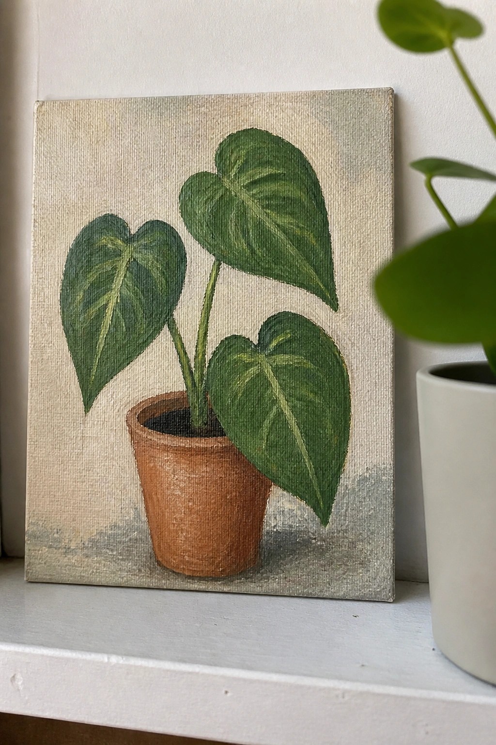 Painting of plant with three large heart-shaped green leaves in terracotta pot
