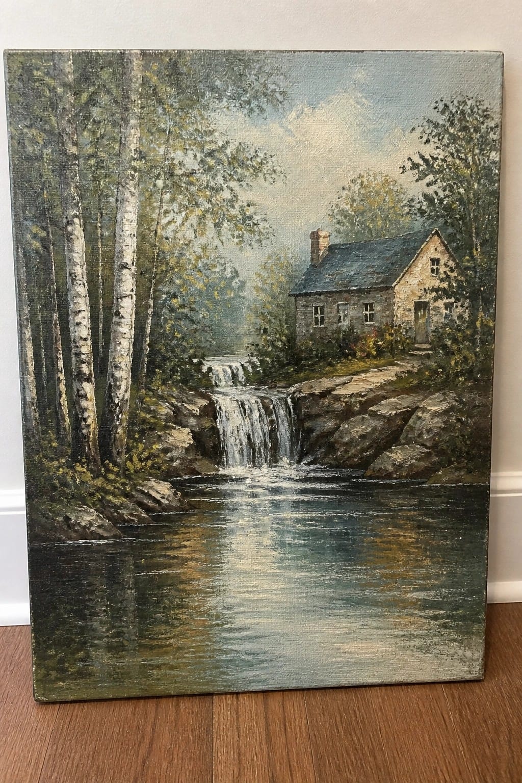 Oil painting of stone cottage by waterfall, river, birch trees, and rocky landscape.