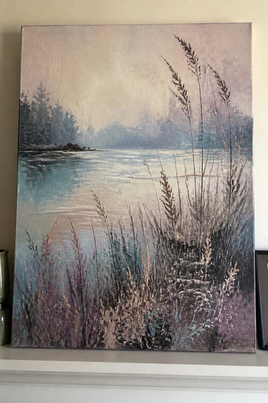 Misty landscape painting of calm blue waters with tall foreground reeds and trees