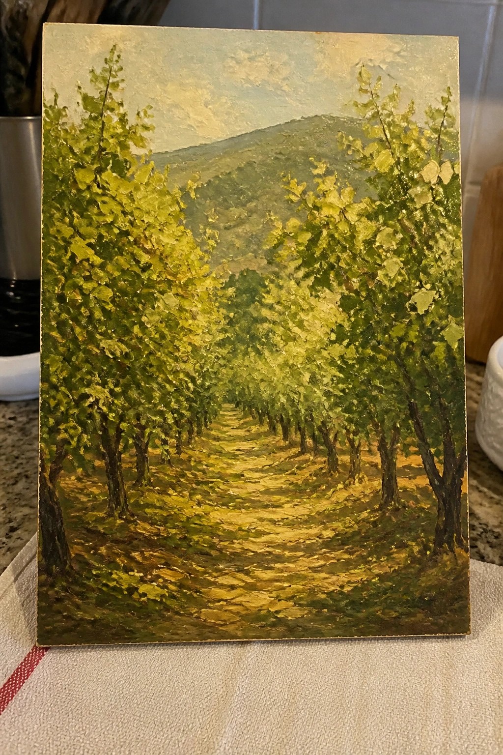Impasto oil painting of sunlit path winding through rows of leafy green trees
