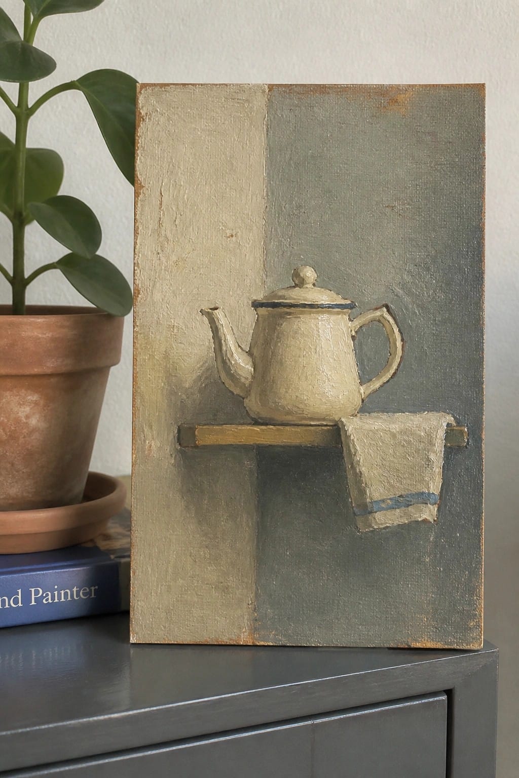 Still life painting of cream teapot on shelf with cloth, beside plant and books