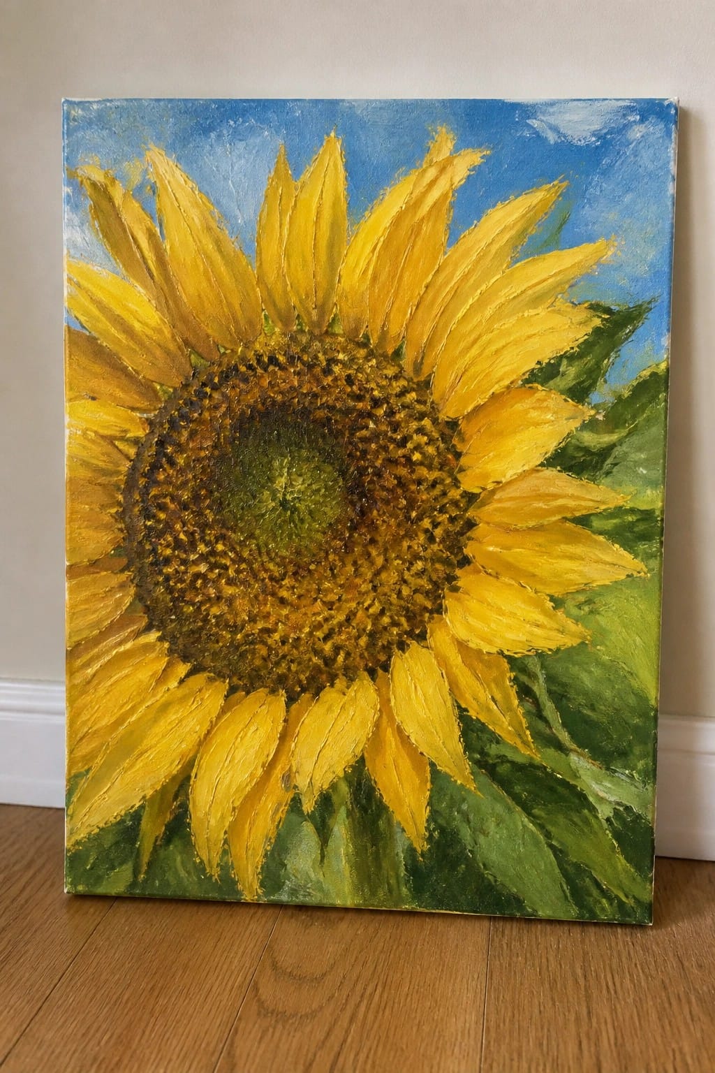 Vibrant yellow sunflower painting with brown center, green leaves, and blue sky background