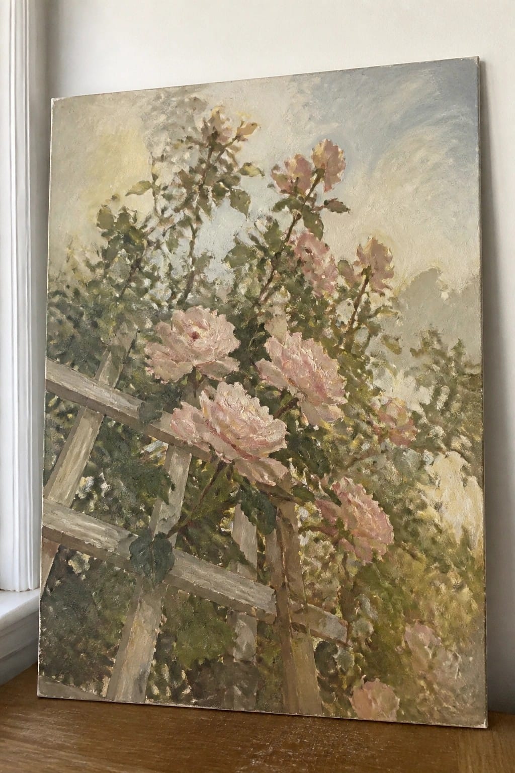 Pink roses bloom on a wooden trellis in an impressionistic oil painting.