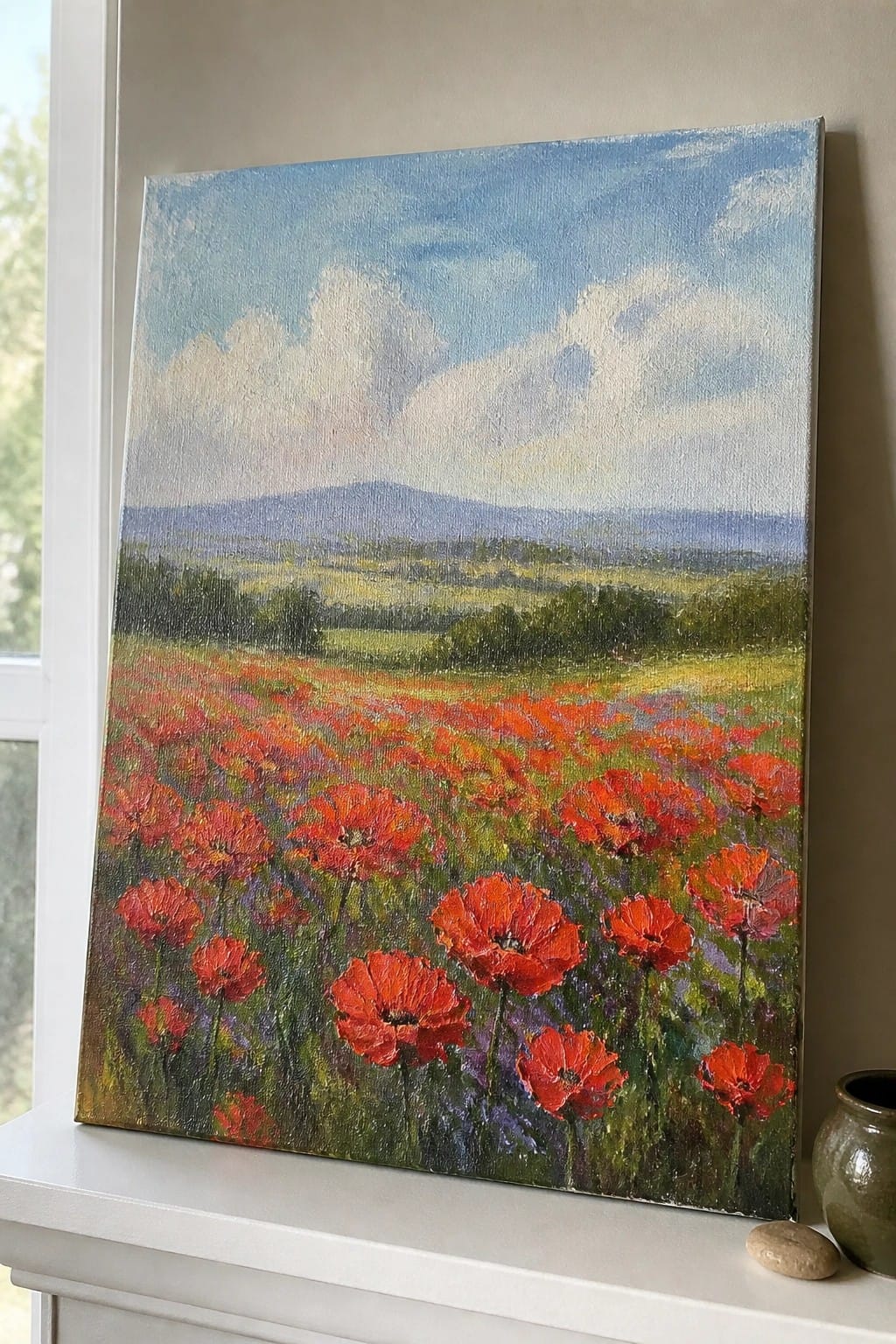 Vivid painting of red poppies in field with mountains under blue sky on ledge