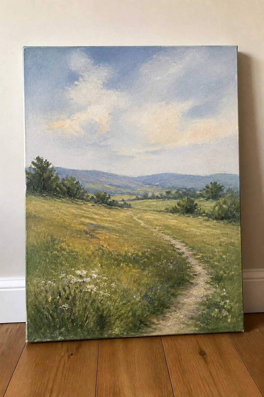 Oil painting of winding dirt path through wildflower meadow with distant green hills