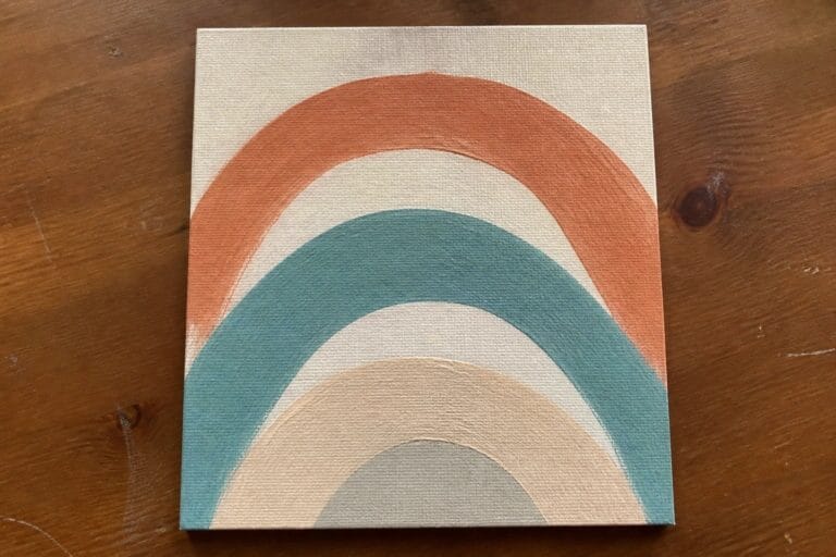 19 Modern Abstract Oil Painting Ideas for Beginners Who Like Clean Shapes Boho rainbow painting on canvas with terracotta, teal, and beige arches on wood.