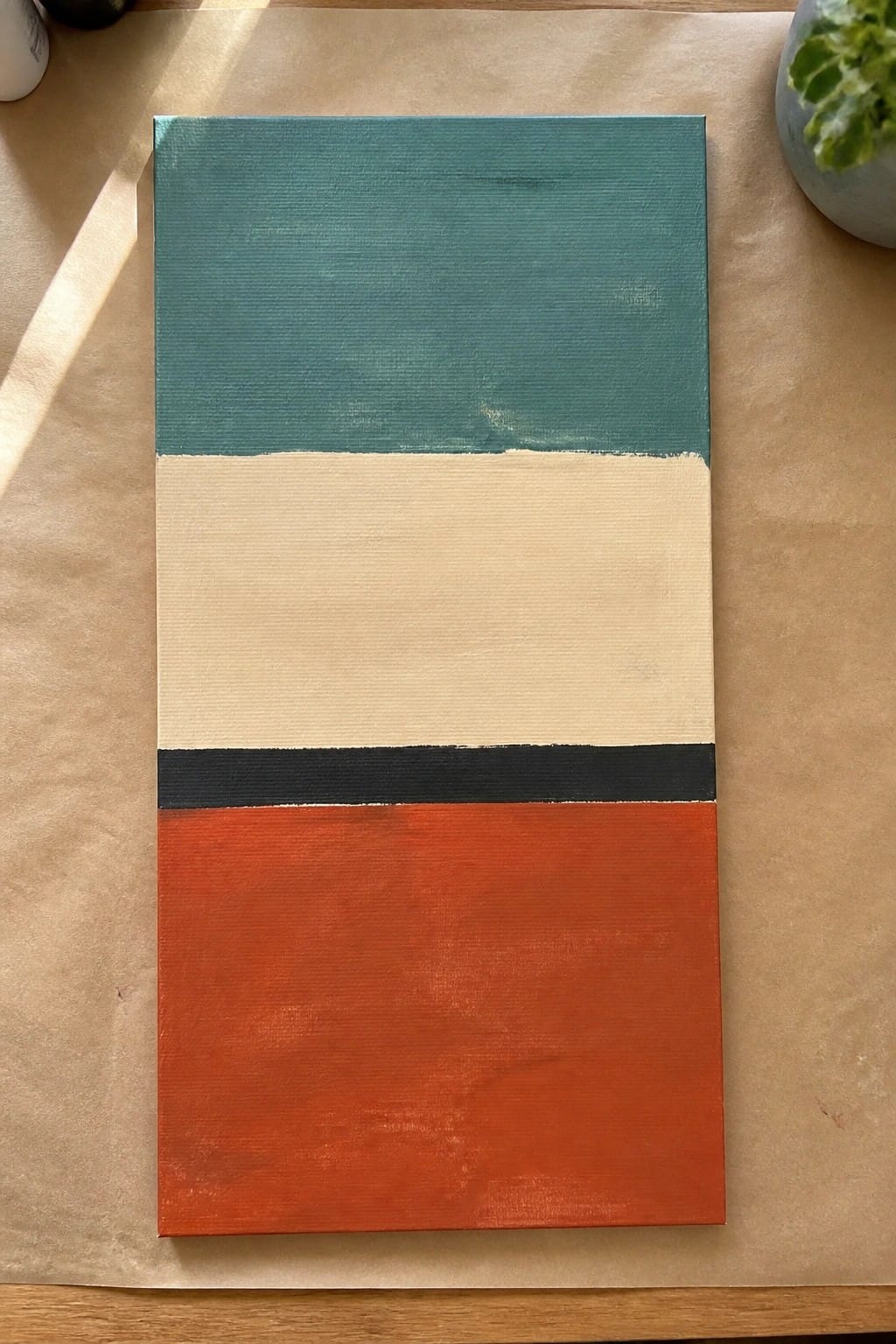 Abstract painting with horizontal teal, cream, black, and orange sections on canvas.