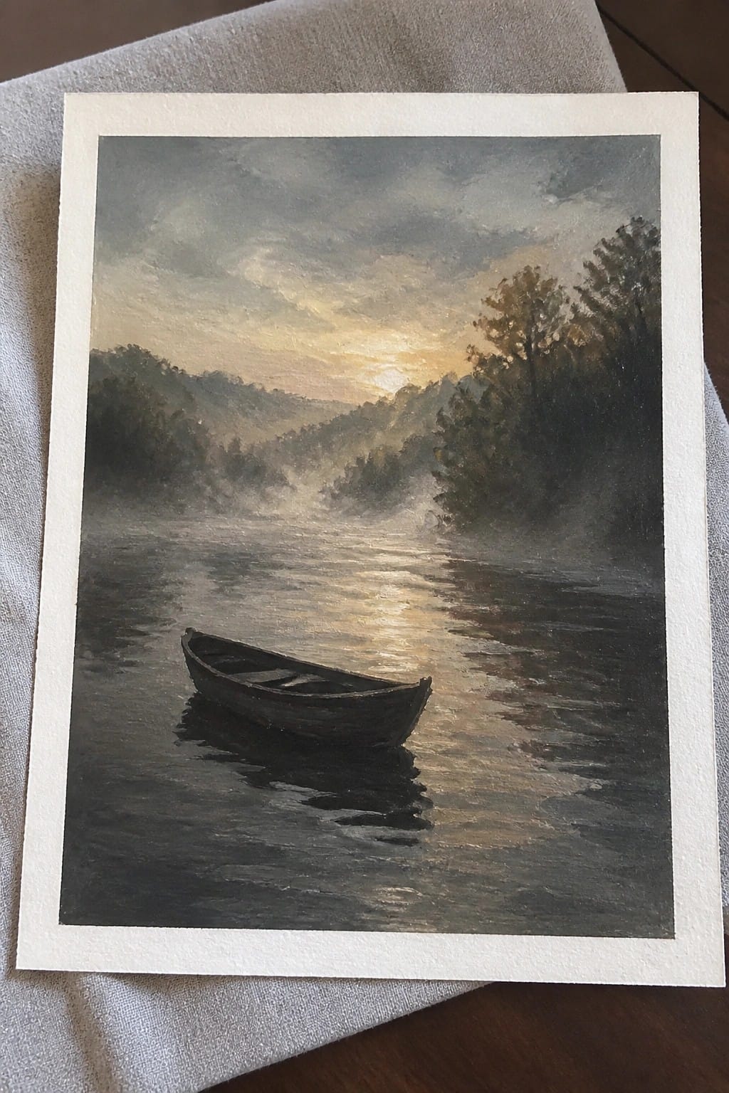 Oil painting of lone rowboat on misty river reflecting golden sunrise over hills